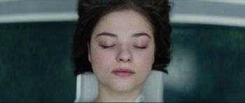 Movie still from “At First Light” (2018), directed by Jason Stone – A person with eyes closed; Close Up shot, Overhead angle