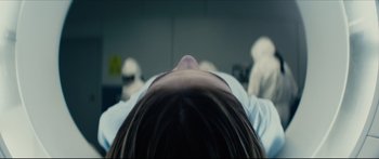 Movie still from “At First Light” (2018), directed by Jason Stone – A woman laying down in a hospital bed with her eyes closed; Close Up shot, Over the shoulder angle
