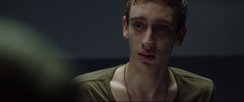 Movie still from “At First Light” (2018), directed by Jason Stone – A young man is looking into the camera; Close Up shot, Over the shoulder angle
