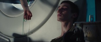 Movie still from “At First Light” (2018), directed by Jason Stone – A man is looking into a mirror in a room; Close Up shot, Low angle