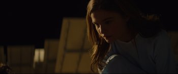 Movie still from “At First Light” (2018), directed by Jason Stone – A woman with long brown hair is looking at the camera; Close Up shot, Low angle