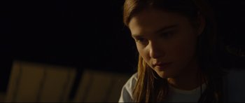 Movie still from “At First Light” (2018), directed by Jason Stone – A person with long brown hair; Close Up shot, Over the shoulder angle