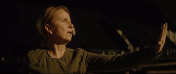 Movie still from “At First Light” (2018), directed by Jason Stone – A woman in a green shirt looking up at the sky; Close Up shot, Low angle