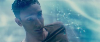 Movie still from “At First Light” (2018), directed by Jason Stone – A young man with headphones looking into the distance; Close Up shot, Overhead angle