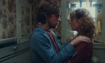Movie still from “Atlantic City” (1980), directed by Louis Malle – A man and a woman standing next to each other in a kitchen; Medium shot, Over the shoulder angle