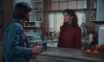 Movie still from “Atlantic City” (1980), directed by Louis Malle – A woman in a red dress talking to a man in a blue shirt; Medium shot, Over the shoulder angle