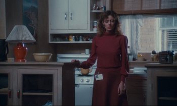 Movie still from “Atlantic City” (1980), directed by Louis Malle – A woman standing in front of an oven in a kitchen; Medium shot, Low angle
