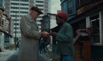 Movie still from “Atlantic City” (1980), directed by Louis Malle – Two men standing on the side of the street; Medium shot, Low angle