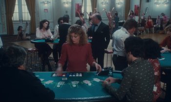 Movie still from “Atlantic City” (1980), directed by Louis Malle – A group of people playing a game at a casino; Wide shot, High angle