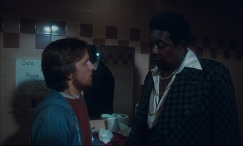 Movie still from “Atlantic City” (1980), directed by Louis Malle – Two men standing next to each other in front of a bathroom mirror; Medium shot, Over the shoulder angle