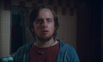 Movie still from “Atlantic City” (1980), directed by Louis Malle – A person wearing a necklace; Close Up shot, Over the shoulder angle