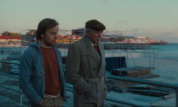 Movie still from “Atlantic City” (1980), directed by Louis Malle – A man and a young man standing next to each other on a pier; Medium shot, Low angle