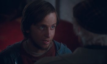 Movie still from “Atlantic City” (1980), directed by Louis Malle – A man sitting in front of another man in front of a window; Close Up shot, Over the shoulder angle