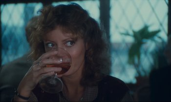 Movie still from “Atlantic City” (1980), directed by Louis Malle – A person holding a glass of wine; Close Up shot, Over the shoulder angle