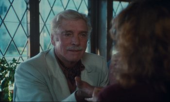 Movie still from “Atlantic City” (1980), directed by Louis Malle – An older man sitting in front of a woman; Close Up shot, Over the shoulder angle