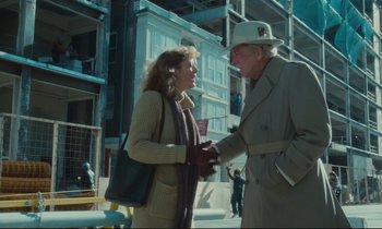 Movie still from “Atlantic City” (1980), directed by Louis Malle – An older man and a younger woman shaking hands; Medium shot, Over the shoulder angle