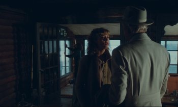 Movie still from “Atlantic City” (1980), directed by Louis Malle – A man and a woman standing next to each other in a room; Medium shot, Over the shoulder angle