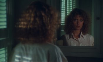 Movie still from “Atlantic City” (1980), directed by Louis Malle – A woman looking in the mirror in front of a window; Close Up shot, Over the shoulder angle