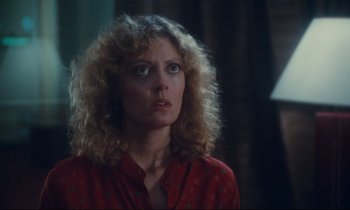 Movie still from “Atlantic City” (1980), directed by Louis Malle – A person with curly hair wearing a red shirt; Close Up shot, Over the shoulder angle