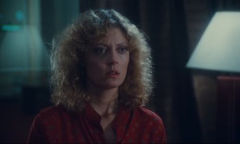 Movie still from “Atlantic City” (1980), directed by Louis Malle – A person with curly hair wearing a red shirt; Close Up shot, Over the shoulder angle