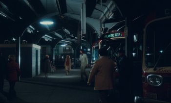 Movie still from “Atlantic City” (1980), directed by Louis Malle – A group of people walking on a sidewalk near a bus stop; Extreme Wide shot, High angle