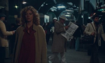 Movie still from “Atlantic City” (1980), directed by Louis Malle – A woman is walking down the street holding a newspaper; Medium shot, Over the shoulder angle