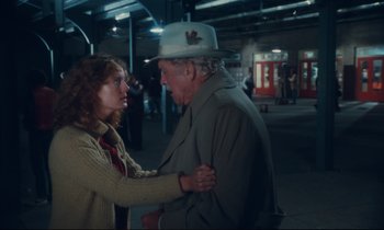 Movie still from “Atlantic City” (1980), directed by Louis Malle – An older man and a younger woman standing next to each other; Medium shot, Over the shoulder angle