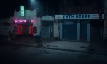 Movie still from “Atlantic City” (1980), directed by Louis Malle – A street corner at night with a trash can on the sidewalk; Extreme Wide shot, High angle