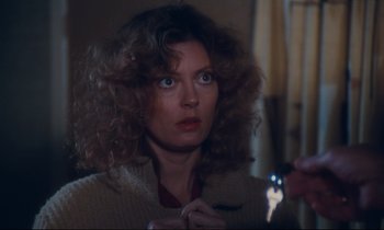 Movie still from “Atlantic City” (1980), directed by Louis Malle – A woman with curly brown hair is holding a cell phone; Close Up shot, Over the shoulder angle