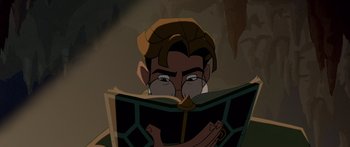 Movie still from “Atlantis: The Lost Empire” (2001), directed by Gary Trousdale – A man with glasses reading a book in the dark; Close Up shot, High angle