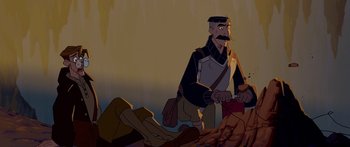 Movie still from “Atlantis: The Lost Empire” (2001), directed by Gary Trousdale – An animated man is standing next to a pile of rocks; Medium shot, High angle