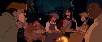 Movie still from “Atlantis: The Lost Empire” (2001), directed by Gary Trousdale – A group of people sitting next to each other in front of a fire; Wide shot, High angle