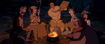 Movie still from “Atlantis: The Lost Empire” (2001), directed by Gary Trousdale – A group of people sitting around a fire pit; Medium shot, High angle