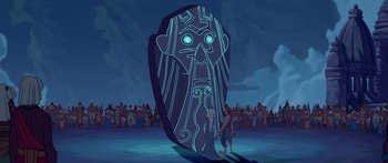 Movie still from “Atlantis: The Lost Empire” (2001), directed by Gary Trousdale – An animated picture of a man standing in front of a giant mask; Extreme Wide shot, Over the shoulder angle