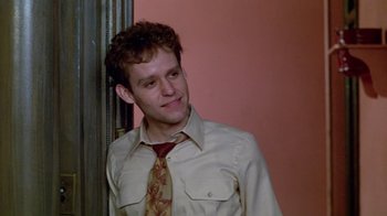 Movie still from “Sophie's Choice” (1982), directed by Alan J. Pakula – A young man wearing a shirt and a tie; Close Up shot, Low angle