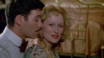 Movie still from “Sophie's Choice” (1982), directed by Alan J. Pakula – A man and a woman are kissing each other; Close Up shot, Over the shoulder angle