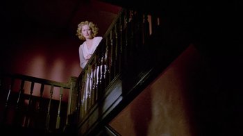 Movie still from “Sophie's Choice” (1982), directed by Alan J. Pakula – A woman standing at the bottom of a staircase; Wide shot, Low angle