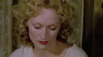 Movie still from “Sophie's Choice” (1982), directed by Alan J. Pakula – A person with curly blonde hair; Close Up shot, Overhead angle