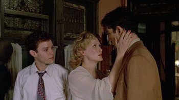 Movie still from “Sophie's Choice” (1982), directed by Alan J. Pakula – A man and a woman touching their noses; Medium shot, Over the shoulder angle