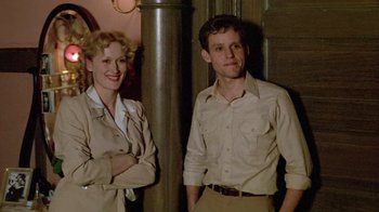 Movie still from “Sophie's Choice” (1982), directed by Alan J. Pakula – A man and a woman standing next to each other; Medium shot, Low angle
