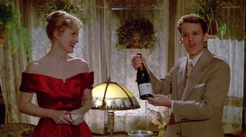 Movie still from “Sophie's Choice” (1982), directed by Alan J. Pakula – A man and a woman holding a bottle of wine; Medium shot, Over the shoulder angle
