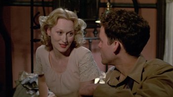 Movie still from “Sophie's Choice” (1982), directed by Alan J. Pakula – A man and a woman sitting at a table talking to each other; Close Up shot, Over the shoulder angle