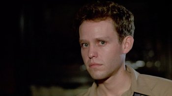 Movie still from “Sophie's Choice” (1982), directed by Alan J. Pakula – A person wearing a brown shirt; Close Up shot, Low angle