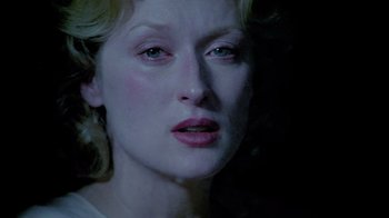 Movie still from “Sophie's Choice” (1982), directed by Alan J. Pakula – A woman's face in the dark; Close Up shot, Low angle