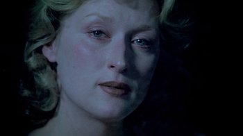 Movie still from “Sophie's Choice” (1982), directed by Alan J. Pakula – A woman's face in the dark; Close Up shot, Low angle