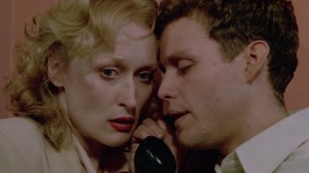 Movie still from “Sophie's Choice” (1982), directed by Alan J. Pakula – A man and a woman talking on a phone; Close Up shot, Overhead angle