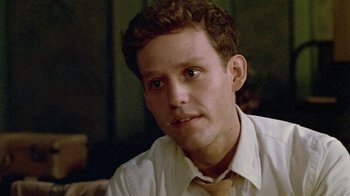 Movie still from “Sophie's Choice” (1982), directed by Alan J. Pakula – A man in a white dress shirt and a tie; Close Up shot, Low angle