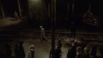 Movie still from “Sophie's Choice” (1982), directed by Alan J. Pakula – A group of people standing on top of a train track; Wide shot, High angle