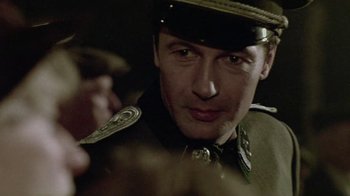 Movie still from “Sophie's Choice” (1982), directed by Alan J. Pakula – A person wearing a uniform; Close Up shot, Over the shoulder angle