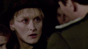 Movie still from “Sophie's Choice” (1982), directed by Alan J. Pakula – A person wearing a hat; Close Up shot, Over the shoulder angle